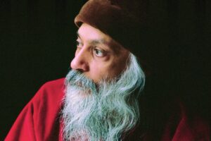 osho in red clothes and his cap